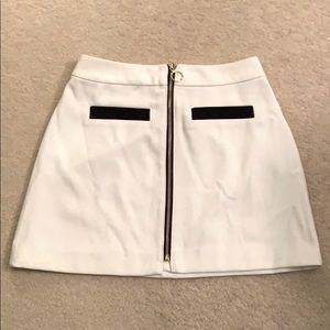 White skirt with black pockets and gold zipper